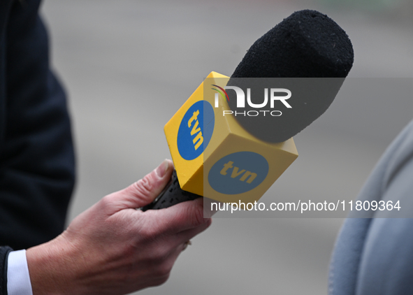 KRAKOW, POLAND - NOVEMBER 24:
A TVN microphone held by a TV reporter outside the venue where Karol Nawrocki was officially introduced as the...