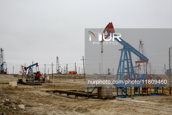 A field of small oil wells is seen in Zabrat, near Baku, Azerbaijan on November 25, 2024. Oil and gas extraction plants are densly installed...