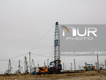 A field of small oil wells is seen in Zabrat, near Baku, Azerbaijan on November 25, 2024. Oil and gas extraction plants are densly installed...