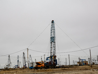 A field of small oil wells is seen in Zabrat, near Baku, Azerbaijan on November 25, 2024. Oil and gas extraction plants are densly installed...