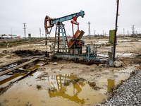 A field of small oil wells is seen in Zabrat, near Baku, Azerbaijan on November 25, 2024. Oil and gas extraction plants are densly installed...