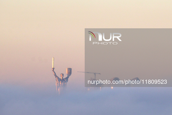 The Motherland monument is seen through the dense fog in Kyiv, Ukraine, on November 25, 2024. 