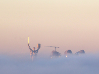 The Motherland monument is seen through the dense fog in Kyiv, Ukraine, on November 25, 2024. (