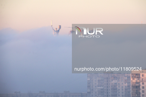 The Motherland monument is seen through the dense fog in Kyiv, Ukraine, on November 25, 2024. 