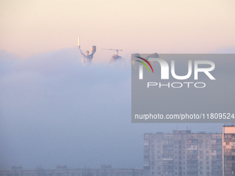 The Motherland monument is seen through the dense fog in Kyiv, Ukraine, on November 25, 2024. (