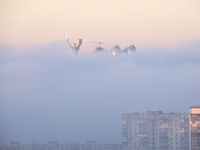 The Motherland monument is seen through the dense fog in Kyiv, Ukraine, on November 25, 2024. (