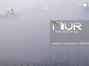 High-rise buildings are seen through the dense fog in Kyiv, Ukraine, on November 25, 2024. NO USE RUSSIA. NO USE BELARUS. (