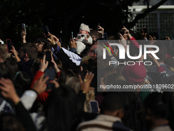 A baby is held above a crowd as President Joe Biden greets people at the 77th anniversary of the National Thanksgiving Turkey presentation o...