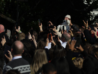 A baby is held above a crowd as President Joe Biden greets people at the 77th anniversary of the National Thanksgiving Turkey presentation o...