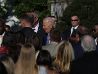 A bee lands on the face of U.S. President Joe Biden as he greets people during the 77th anniversary of the National Thanksgiving Turkey pres...