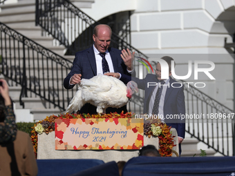 National Turkey Foundation chairman John Zimmerman and his son Grant present a turkey the 77th anniversary of the National Thanksgiving Turk...