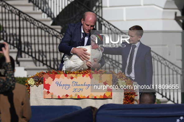 National Turkey Foundation chairman John Zimmerman and his son Grant present a turkey the 77th anniversary of the National Thanksgiving Turk...