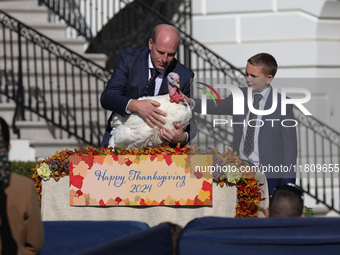 National Turkey Foundation chairman John Zimmerman and his son Grant present a turkey the 77th anniversary of the National Thanksgiving Turk...