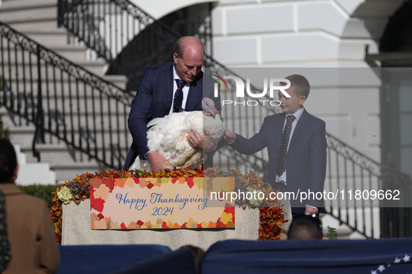 National Turkey Foundation chairman John Zimmerman and his son Grant present a turkey the 77th anniversary of the National Thanksgiving Turk...