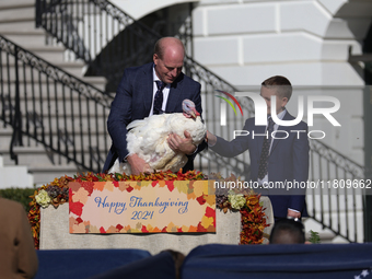 National Turkey Foundation chairman John Zimmerman and his son Grant present a turkey the 77th anniversary of the National Thanksgiving Turk...