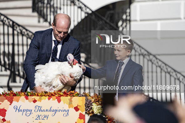 On November 25, 2024, in Washington, D.C., President Joe Biden pardons Peach and Blossom, two Minnesota turkeys, at an event on the South La...