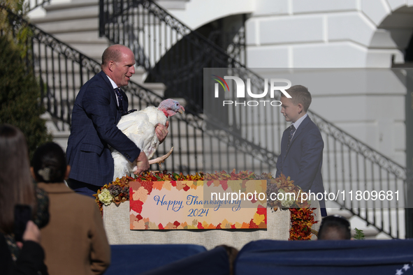 National Turkey Foundation chairman John Zimmerman and his son Grant present a turkey the 77th anniversary of the National Thanksgiving Turk...