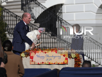 National Turkey Foundation chairman John Zimmerman and his son Grant present a turkey the 77th anniversary of the National Thanksgiving Turk...