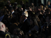 A person wears a hat resembling a turkey at the 77th anniversary of the National Thanksgiving Turkey presentation on the South Lawn of the W...