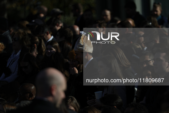 A person wears a hat resembling a turkey at the 77th anniversary of the National Thanksgiving Turkey presentation on the South Lawn of the W...