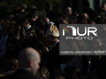 A person wears a hat resembling a turkey at the 77th anniversary of the National Thanksgiving Turkey presentation on the South Lawn of the W...