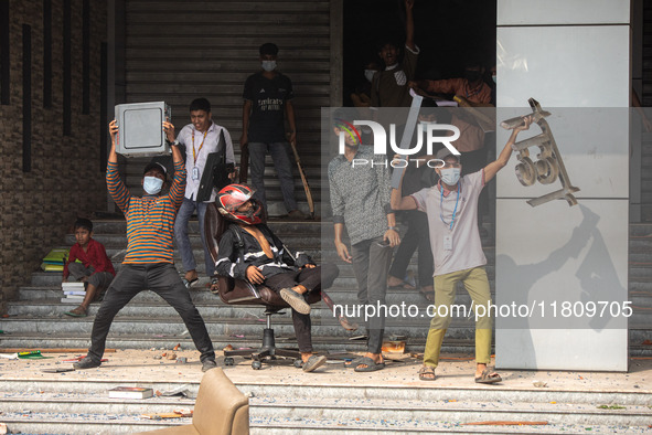 Students of Kabi Nazrul College and Suhrawardy College celebrate after vandalizing the campus of Dr. Mahbubur Rahman Molla College in Dhaka,...