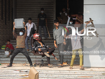 Students of Kabi Nazrul College and Suhrawardy College celebrate after vandalizing the campus of Dr. Mahbubur Rahman Molla College in Dhaka,...