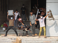 Students of Kabi Nazrul College and Suhrawardy College celebrate after vandalizing the campus of Dr. Mahbubur Rahman Molla College in Dhaka,...