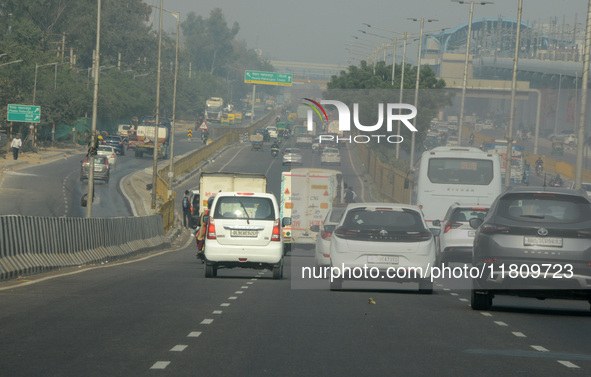 Vehicles travel on the roads during smoggy conditions in New Delhi, India, on November 24, 2024. 