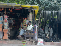 An Indian man sits at his roadside shop in New Delhi, India, on November 24, 2024. (