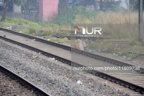 An Indian woman sits on railway tracks in Silout, Bihar, India, on November 24, 2024. 