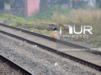 An Indian woman sits on railway tracks in Silout, Bihar, India, on November 24, 2024. (