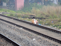 An Indian woman sits on railway tracks in Silout, Bihar, India, on November 24, 2024. (