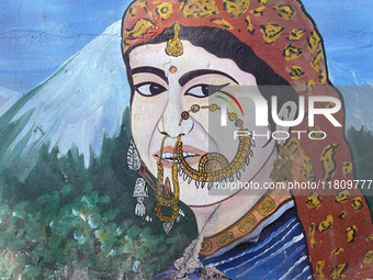 A mural of a traditional Kumaon village woman is along the Mall Road in Mussoorie, Uttarakhand, India, on April 18, 2024. (