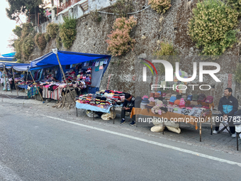 People sell clothing along the Mall Road in Mussoorie, Uttarakhand, India, on April 18, 2024. (