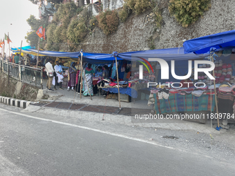 People sell clothing along the Mall Road in Mussoorie, Uttarakhand, India, on April 18, 2024. (