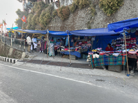 People sell clothing along the Mall Road in Mussoorie, Uttarakhand, India, on April 18, 2024. (