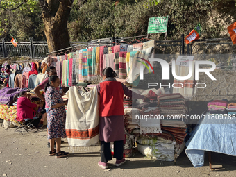 People sell clothing along the Mall Road in Mussoorie, Uttarakhand, India, on April 18, 2024. (