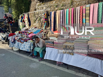 A woman sells clothing along the Mall Road in Mussoorie, Uttarakhand, India, on April 18, 2024. (