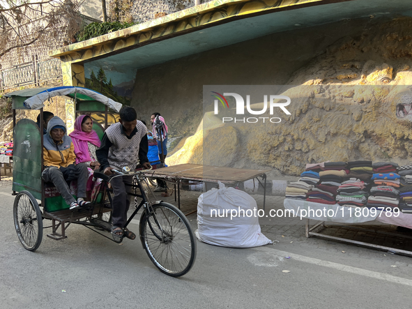 A rickshaw driver ferries people along the Mall Road in Mussoorie, Uttarakhand, India, on April 18, 2024. 