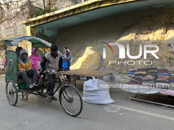 A rickshaw driver ferries people along the Mall Road in Mussoorie, Uttarakhand, India, on April 18, 2024. (