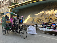 A rickshaw driver ferries people along the Mall Road in Mussoorie, Uttarakhand, India, on April 18, 2024. (