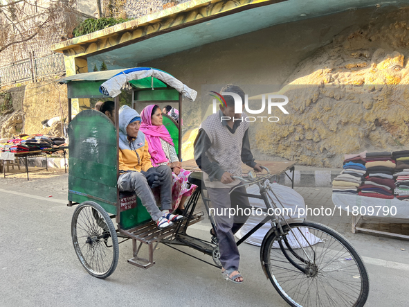 A rickshaw driver ferries people along the Mall Road in Mussoorie, Uttarakhand, India, on April 18, 2024. 