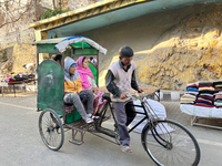 A rickshaw driver ferries people along the Mall Road in Mussoorie, Uttarakhand, India, on April 18, 2024. (