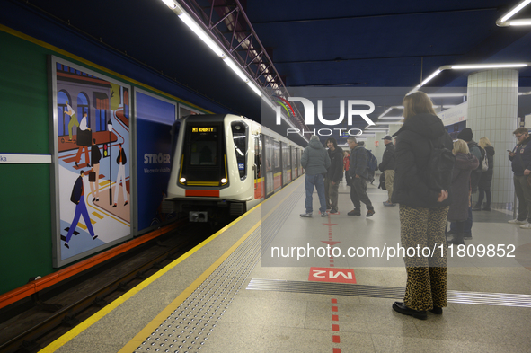 People wait for the metro during Black Friday week in Warsaw, Poland, on November 25, 2024. 