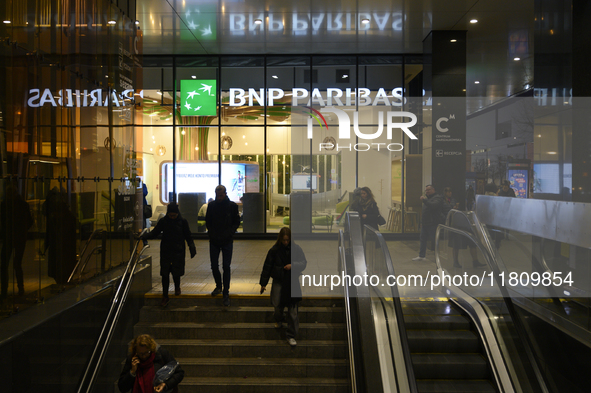 People walk past a BNP Paribas bank in Warsaw, Poland, on November 25, 2024. 