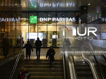 People walk past a BNP Paribas bank in Warsaw, Poland, on November 25, 2024. (