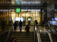 People walk past a BNP Paribas bank in Warsaw, Poland, on November 25, 2024. (