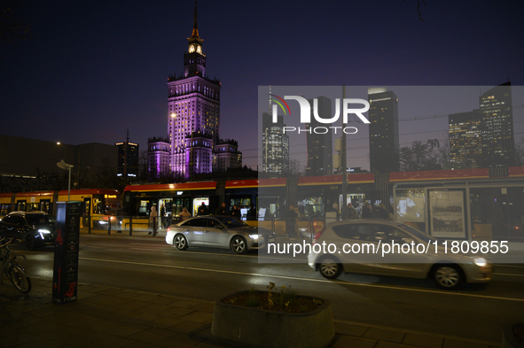 Cars and trams drive past the Palace of Culture and Science in Warsaw, Poland, on November 25, 2024. 