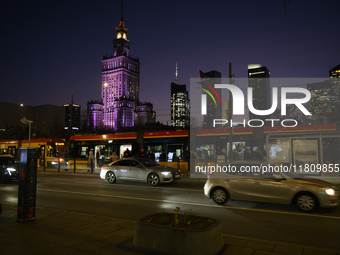 Cars and trams drive past the Palace of Culture and Science in Warsaw, Poland, on November 25, 2024. (